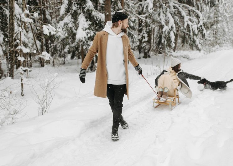 A Man Pulling a Woman on a Sleigh